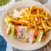 Turkey Club Sandwich · Served with bacon, lettuce and tomato. Served with french fries, coleslaw and pickles.