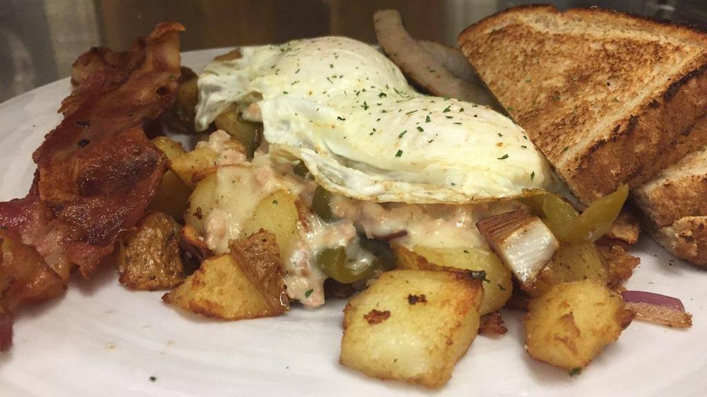 Breakfast Plate · Loaded homefries (peppers and onions) smothered with homemade sausage gravy topped with two eggs, two strips of bacon, two sausage links and white or wheat toast.