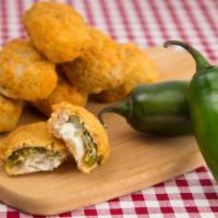 Jalapeño Poppers · Juicy jalapeño poppers breaded and filled with cheese and fried to golden perfection.