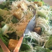 Caesar · Romaine Lettuce, croutons, shaved parmesan with caesar dressing.