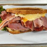 Classic Reuben · Corned beef, melted Swiss cheese and sauerkraut topped with russian dressing on grilled rye.