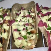 Pollo · 3 per order. Marinated Chicken, pickled red onion, sliced avocado topped with jalapeno avoca...