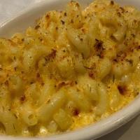 Mac And Cheese · Elbow macaroni in a rich cream sauce topped with seasoned bread crumbs.
