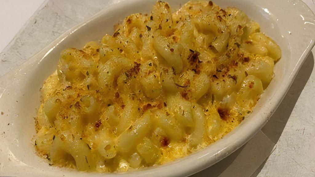 Mac And Cheese · Elbow macaroni in a rich cream sauce topped with seasoned bread crumbs.