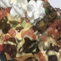 Nacho Platter For The Table · Seasoned beef, beans, diced tomatoes and jalapenos topped with a three cheese blend and sour...