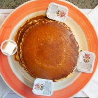 Pancakes · Three pancakes served with syrup and butter on the side