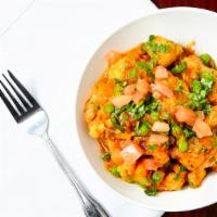 Aloo Gobi Muttar · Onion tomato based curry with potatoes and cauliflower and green peas.