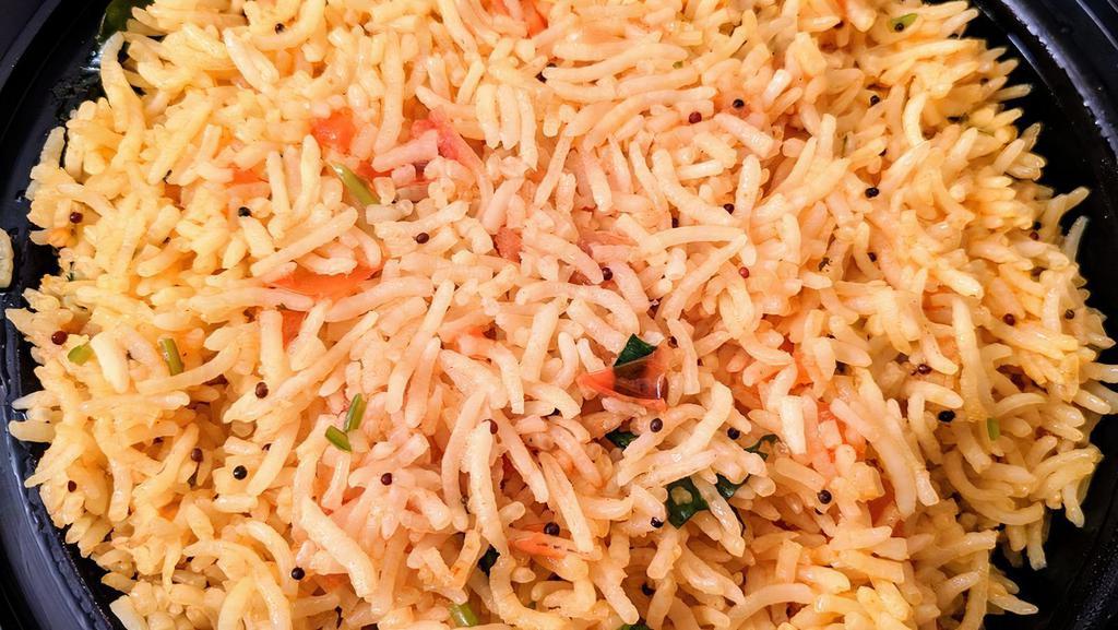 Tomato Rice · Tomato flavored basmati rice tempered with mustard seeds and curry leaves.