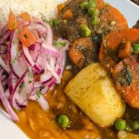 Seco De Carne · Beef Stew With Peas & Carrots In Cilantro Sauce. Served With Rice & Beans.