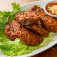 Fish Cakes · Fried curry fish cakes with sweet cucumber sauce.