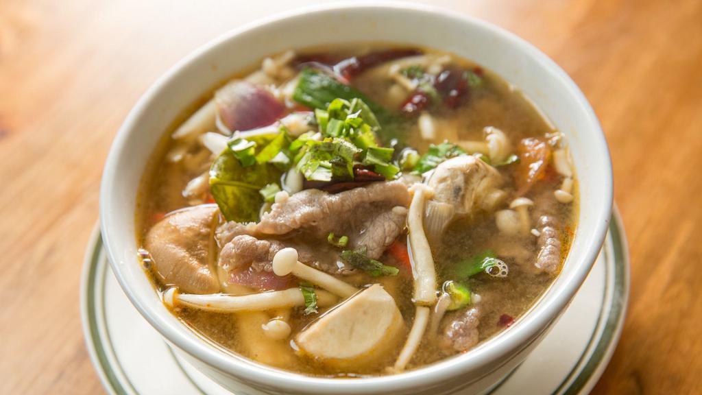 Tom Zabb · Pork broth based. Spicy and sour soup with mushrooms, tomatoes, and scallions.