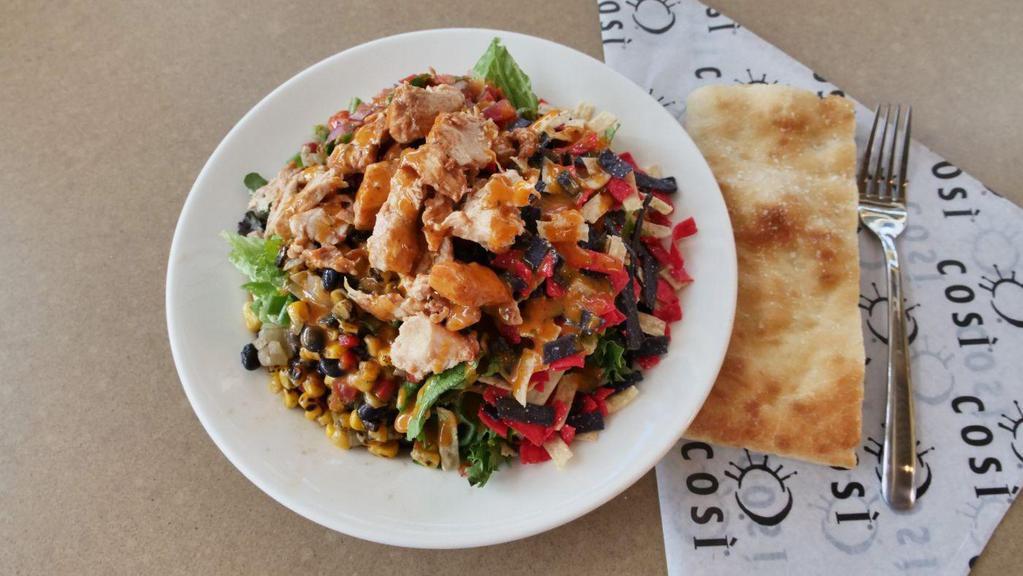 Adobo Lime Chicken · rotisserie chicken on top of seasonal mixed greens, tossed with fire roasted corn and black bean salsa, crispy tortilla strips, house-made pico de gallo and adobo vinaigrette