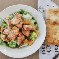 Chicken Caesar · rotisserie chicken on top of crisp romaine lettuce tossed with seasoned croutons, grated par...
