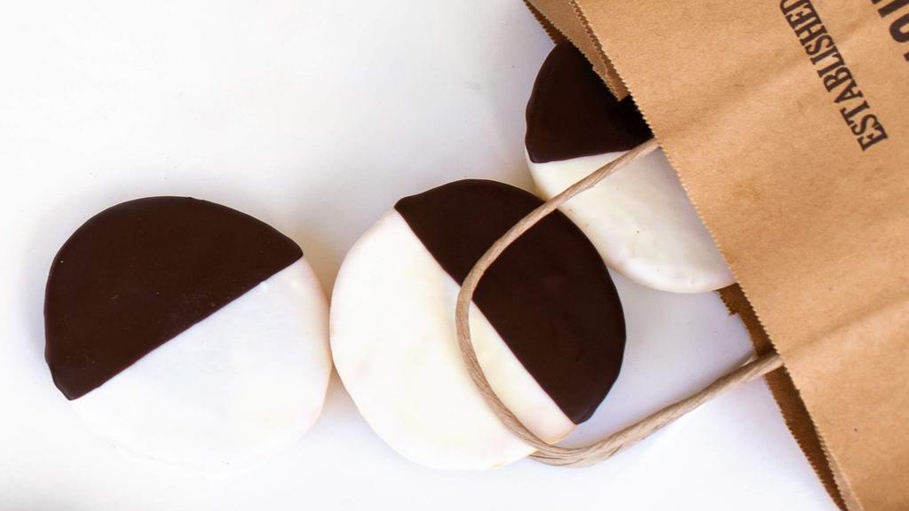 Black & White Cookie · Russ & Daughters bakes the best black & white cookie in New York! The cookie itself is delicate with hints of lemon and almond, and creamy chocolate and vanilla icing make this a true classic. (contains almond extract)
