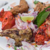 Tandoori Mixed Grill Platter · Assorted grilled tandoori chicken, chicken tikka, reshmi kebab, chicken seekh kebab and choi...