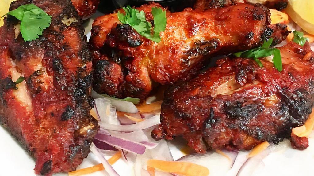 Tandoori Chicken Wings · Chicken wings marinated with spices and yogurt, grilled in our clay oven.