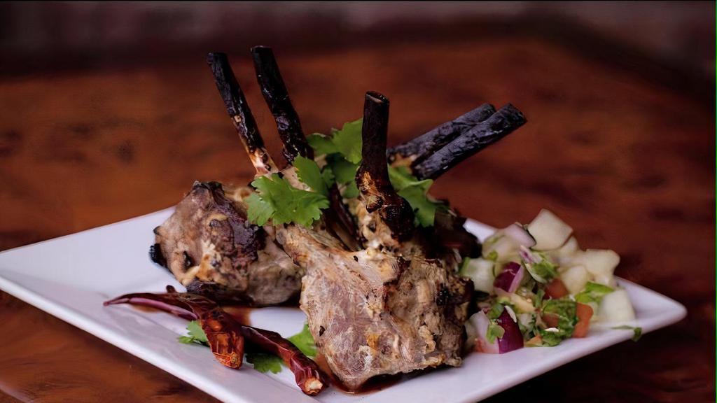Lamb Chops · House special. Four pieces of lamb chop marinated with our very special blend of spices and cooked in our clay oven served with 8 oz. rice & fresh Calcutta salad.