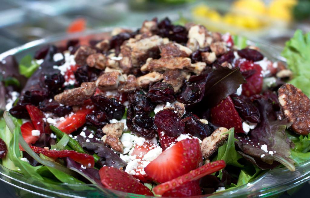 Basil Salad · Strawberry, candied walnuts, goat cheese, and dried cranberries over mesclun with raspberry vinaigrette.