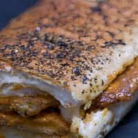 Oasis Panini · Cuban roast pork, ham, sliced pickles, and Swiss cheese on garlic bread with spicy honey mus...