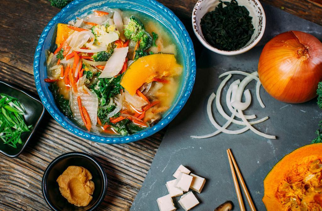 Earthy Miso Soup Bowl · Shiitake, tofu, Napa, carrot, onion, wakame, kabocha, greens, broccoli, ginger, scallions, and gluten free miso.