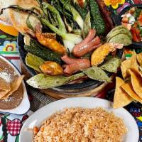 Molcajete · Serves approx. 2 ppl.
Mexican rice, refried beans, tortillas, pico de gallo, cheese, nopales...