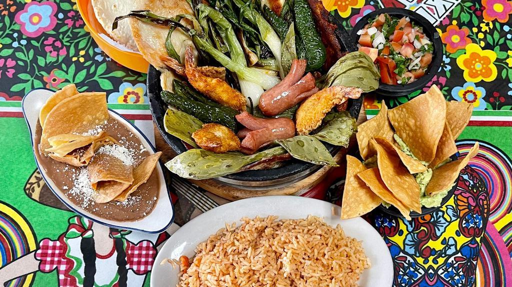 Molcajete · Serves approx. 2 ppl.
Mexican rice, refried beans, tortillas, pico de gallo, cheese, nopales, guacamole, breaded shrimp, al pastor, grilled chicken, grilled steak and carne enchilada
