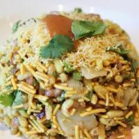 Vegan Bhelpuri · Puffed rice and potato, topped with onions and cilantro. Contains gluten.