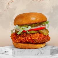 Spicy Fried Chicken · Crispy fried chicken, sliced tomatoes, shredded lettuce, and hot sauce.
