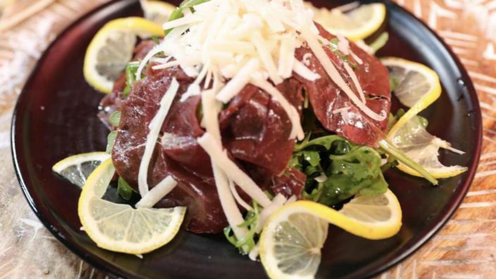 Bresaola · Baby fresh arugula, sliced bresaola marinated in lemon vinaigrette and extra virgin olive oil dressing, shaved Parmigiano Reggiano