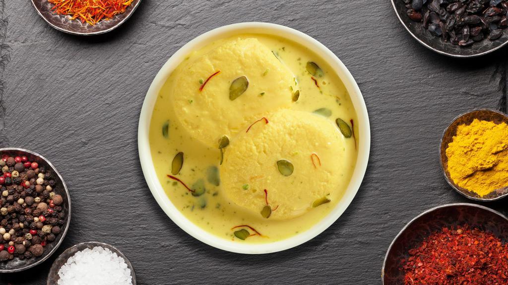 Rasmalai · Soft cottage cheese balls flavored with cardamom and saffron served in chilled creamy milk.