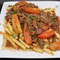 Lomo Saltado · Sauteed beef with onions and tomatoes, served over fries and rice.