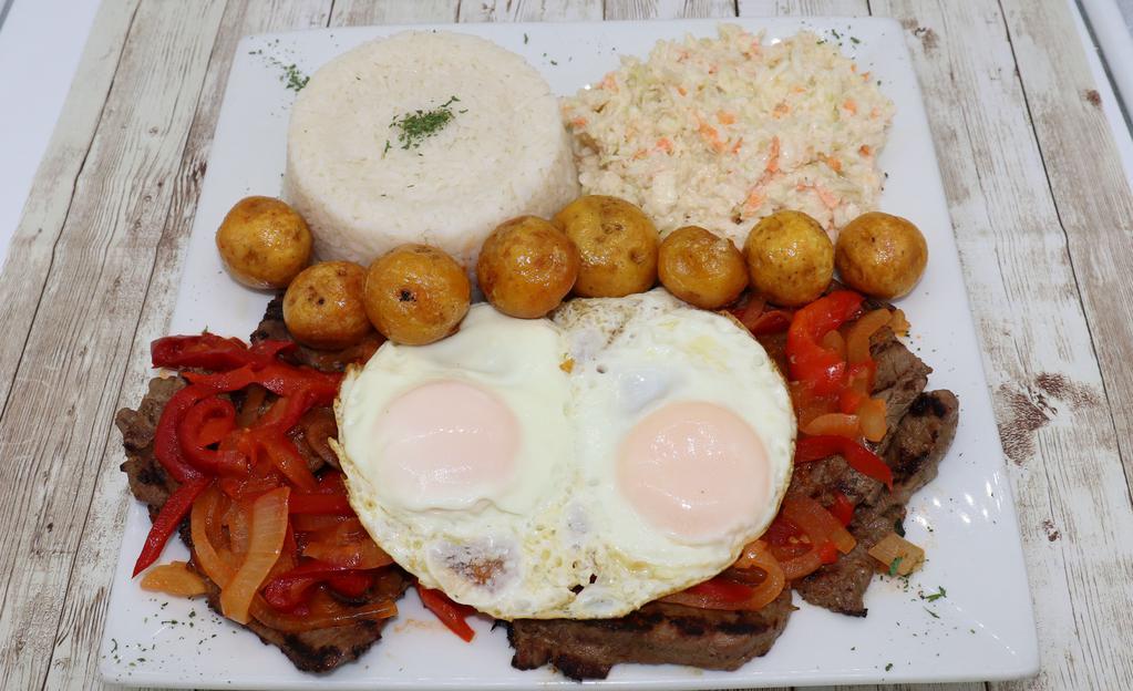 Bistek A Caballo · Grilled steak with sunny side up eggs & Colombian Sauce.Rice and  2 sides