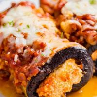 Eggplant Rollatini · Rolled breaded eggplant filled with a delicate ricotta cheese and spinach blend, baked with ...