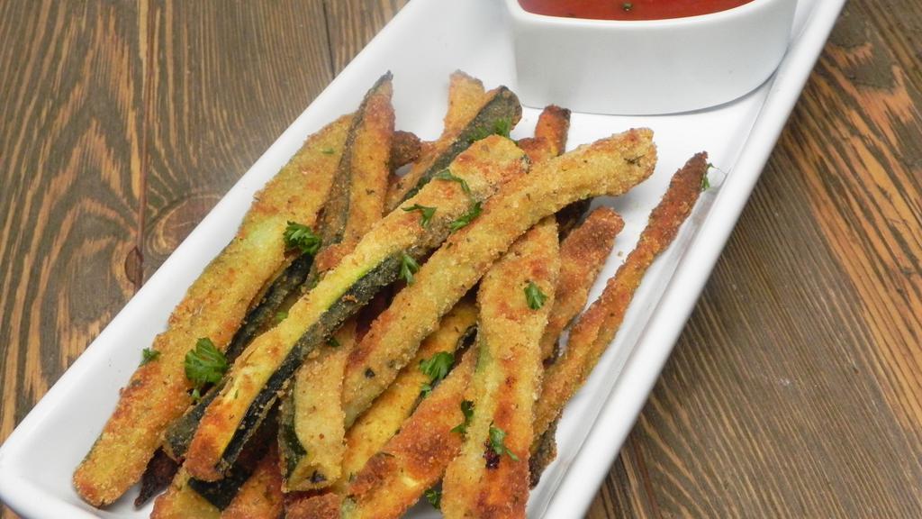 Zucchini Sticks · Lightly breaded zucchini sticks served with tomato sauce.