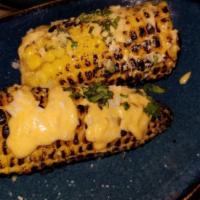 Elote Mexican Street Corn · Gluten free. Charred corn on the cob, chili lime aioli, cilantro, crumbled cotija.