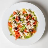 Our Famous Greek Salad · Mixed garden-style greens topped with feta cheese, cucumbers, tomatoes, peppers, onions, and...