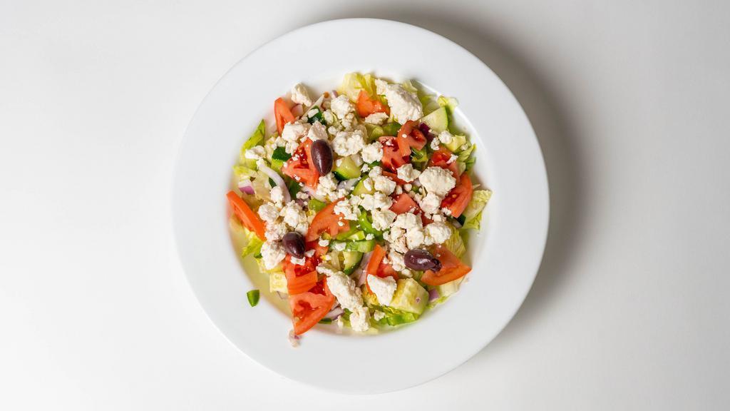 Our Famous Greek Salad · Mixed garden-style greens topped with feta cheese, cucumbers, tomatoes, peppers, onions, and black olives.