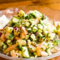 Mediterranean Chopped Salad Bowl · Tomato, cucumber, onion, parsley and mint with lemon and EVOO.