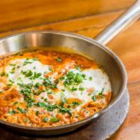 Shakshuka · Tomatoes and pepper stew and two eggs over easy.
