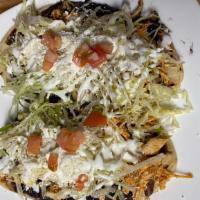 Huarache · Served with lettuce, tomatoes, cotija cheese and sour cream.