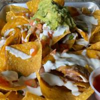 Nachos Grande · Grilled chicken, ground beef chili, pulled pork, or vegetarian. Tortilla chips layered with ...