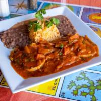 Lengua Guisada · Beef tongue cooked in homemade tomato sauce served with rice, beans and corn tortillas.