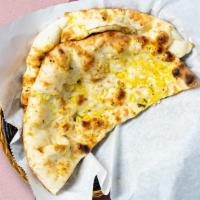 There'S Naan Better · Freshly baked leavened bread in a clay oven garnished with garlic and butter.