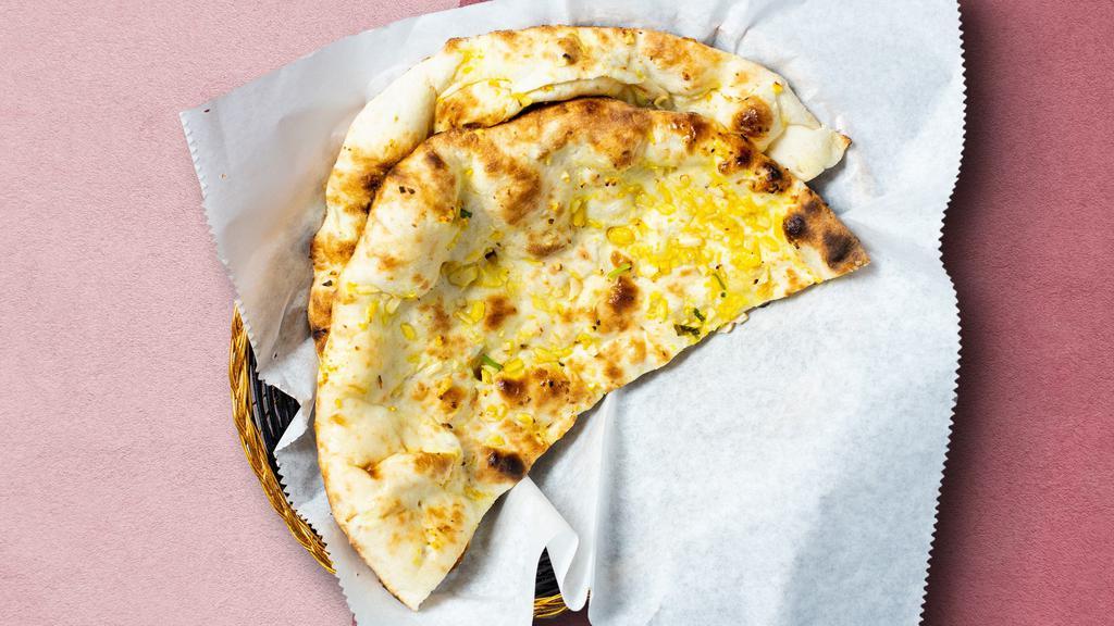 There'S Naan Better · Freshly baked leavened bread in a clay oven garnished with garlic and butter.