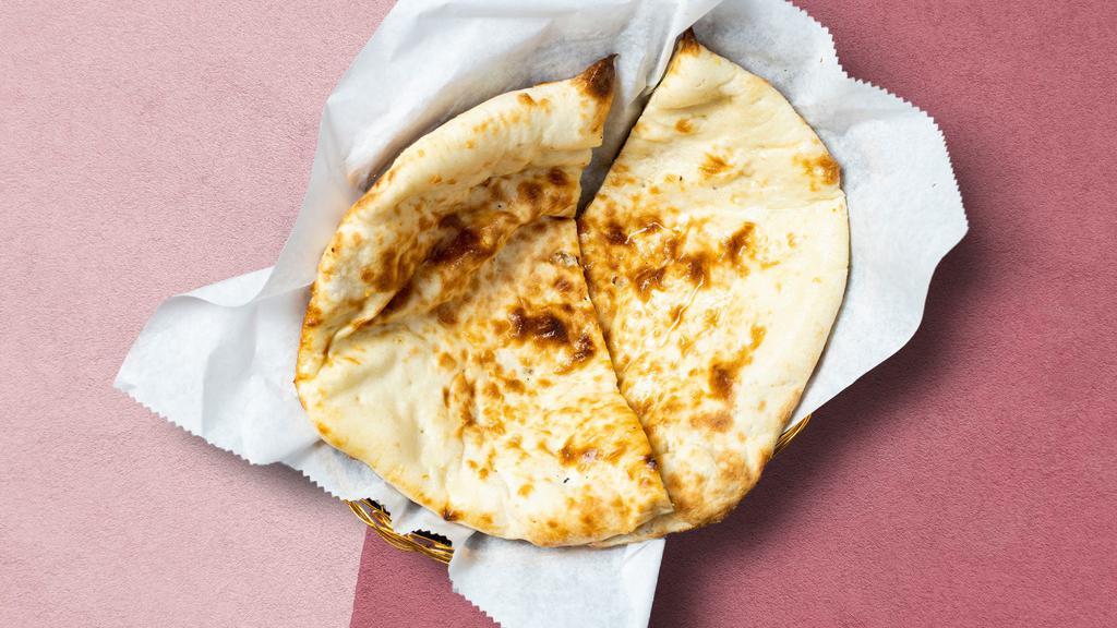 Second To Naan · Freshly baked leavened bread in a clay oven garnished with butter.