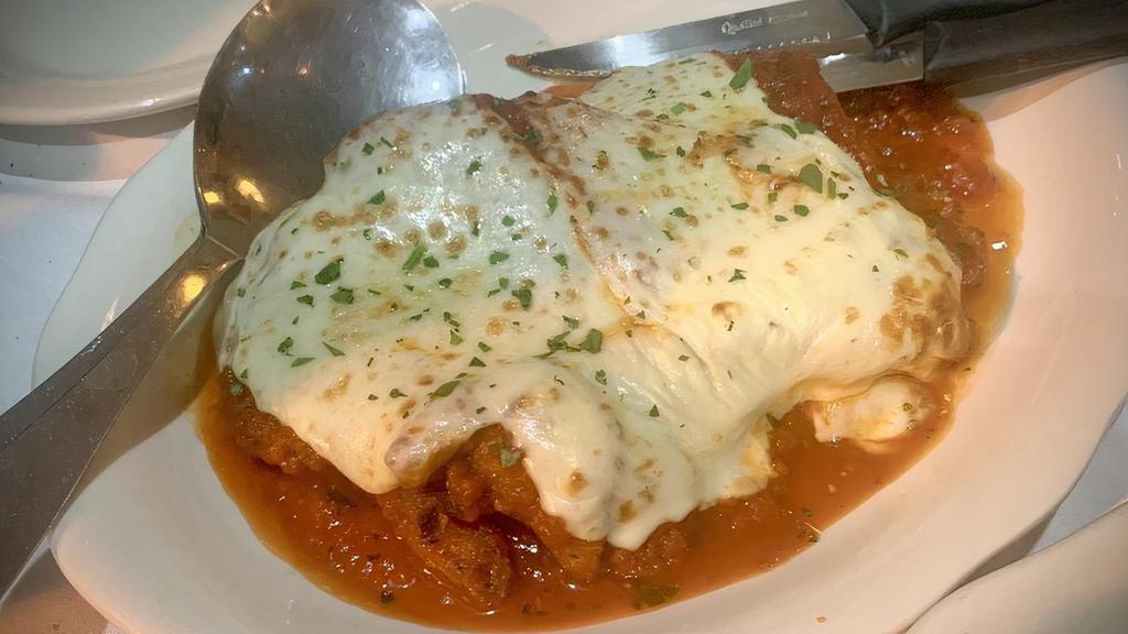 Chicken Parmigiana · Lightly breaded and topped with mozzarella cheese and marinara sauce.