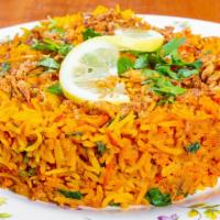 Chicken Biryani · Aromatic Indian basmati rice steam-cooked with boneless cubes of chicken and fresh herbs.