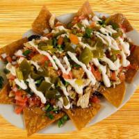 Nachos · Fried tortilla chips topped with your choice of meat, refried black beans, pico de gallo, Me...