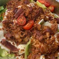 Wedge Salad · Half head of iceberg lettuce, bacon, tomatoes, homemade blue cheese dressing, crispy fried o...