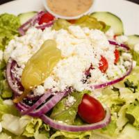 Greek Salad · Romaine, tomatoes, cucumbers, feta cheese, grape leaves, olives, pepperoncini and onions.